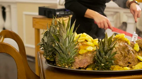 Waiter cuts the pork with pineapple Stock Footage 68025525