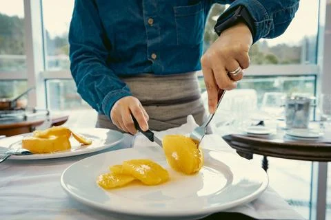 Waiter demonstrating fine dining table service Stock Photos