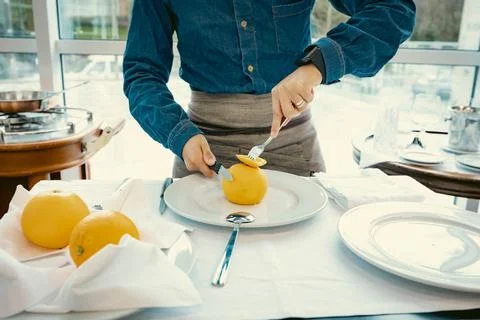 Waiter demonstrating fine dining table service Stock Photos
