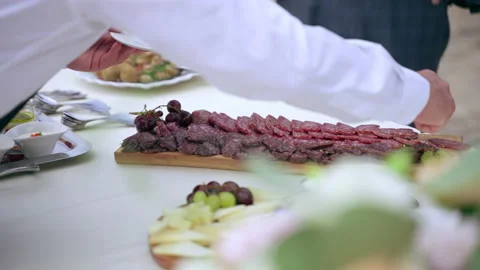 Waiter dressed in uniform serving guests at luxury wedding party outdoors Video stock 158688988