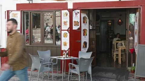 Waiter with Drinks in Front of Empty Table in Restaurant Area Stock Footage 285254768