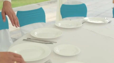 The waiter gently corrects cutlery on the table with a white cloth on the Video stock 52607385