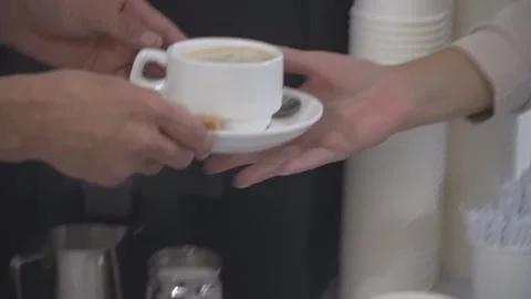 The waiter gives the client a cup of coffee Stock Footage 163479903
