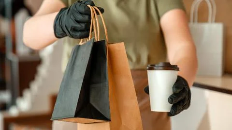 Waiter giving takeout meal while city covid 19 lockdown, coronavirus shutdown Stock Photos
