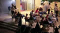 Waiter greeting guests and showing them a free table. HD Footage