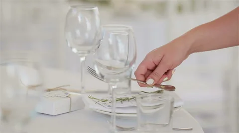 Waiter hands arranging table setting with place card for guests in a restaurant Stock Footage 62192555