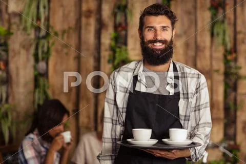 Waiter holding a tray with coffees Stock Photos