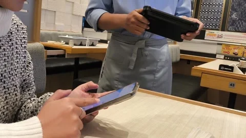 Waiter holds tablet, takes order with smile Stock Footage 340217445