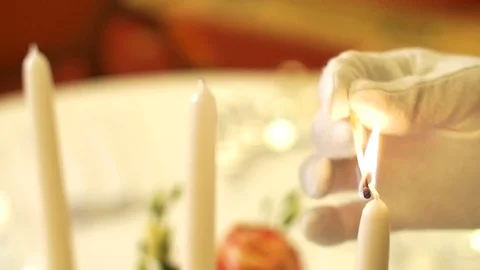 Waiter lit candles on the table Stock Footage 71468049