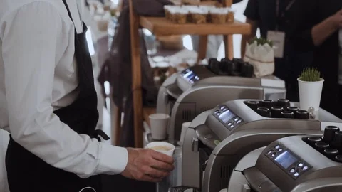 The waiter makes coffee in a coffee machine at a big event Stock Footage 104495514