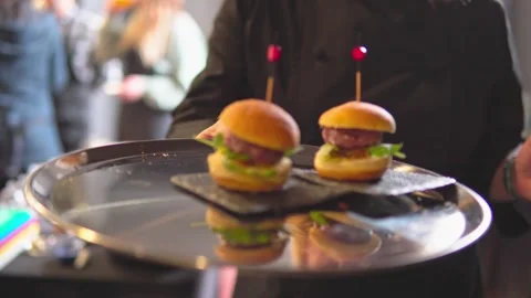 Waiter offering mini burger snack tapas on a tray Stock Footage 269063075