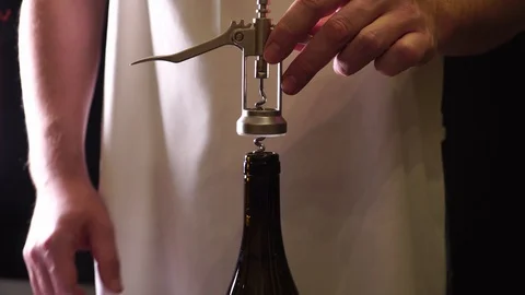 Waiter opens a bottle of champagne Stock Footage 121417228