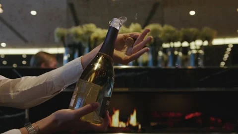 The waiter opens a bottle of champagne Stock Footage 171413140