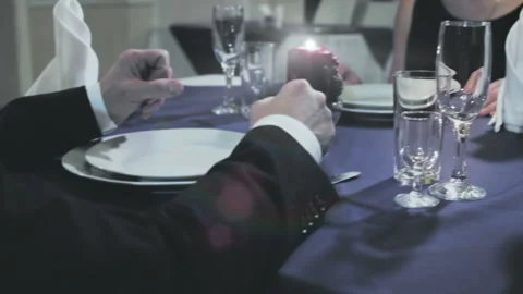 The waiter opens standing on the table A couple of champagne rips off his foil Stock-Footage 97578315