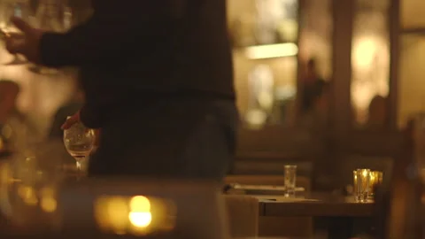 Waiter Picking Up Glassware on Tables at an Upscale Restaurant Video stock 141083223