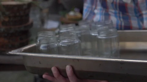 Waiter placing out mason jar glasses at hip restaurant Stock Footage 108564684