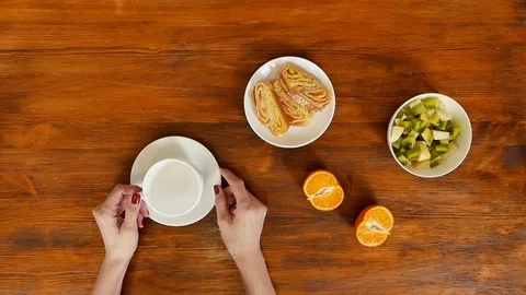 Waiter pouring coffee to client in cafe Stock Footage 70987804