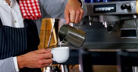 Waiter pouring milk in coffee Stock Footage