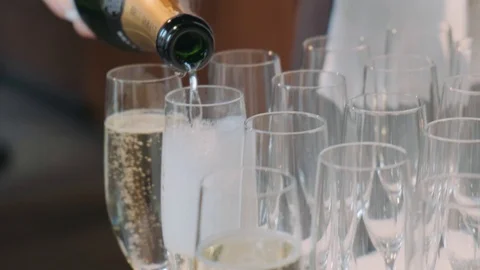 Waiter pours champagne on glasses on wedding Stock Footage 127381753