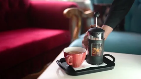The waiter pours the winter tea brewed on the table into a glass Stock Footage 194351731