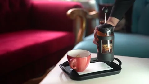 The waiter pours the winter tea brewed on the table into a glass Stock Footage 196199959