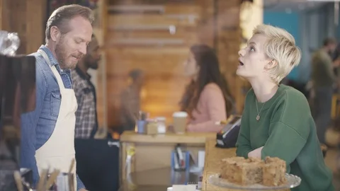 Waiter preparing and serving coffee to customer at coffee shop counter Video stock 108016116