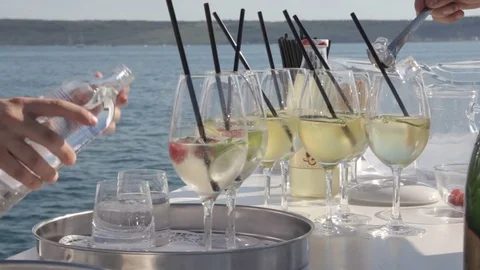 Waiter preparing cockail drinks for guests Stock Footage 83787423