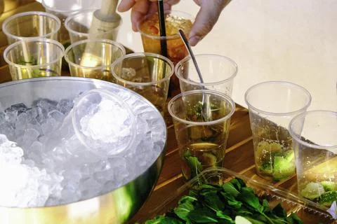 Waiter preparing mojitos with mint and ice. Stock Photos