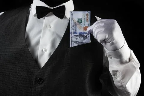 Waiter pulling out dollars in white glove. Foto stock