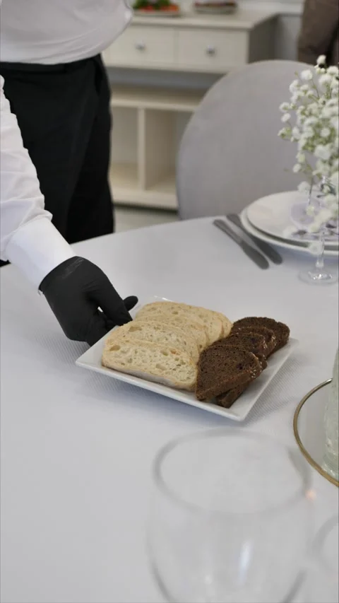 Waiter puts dish on table. festive table setting. luxury event organization Stock Footage 306885035