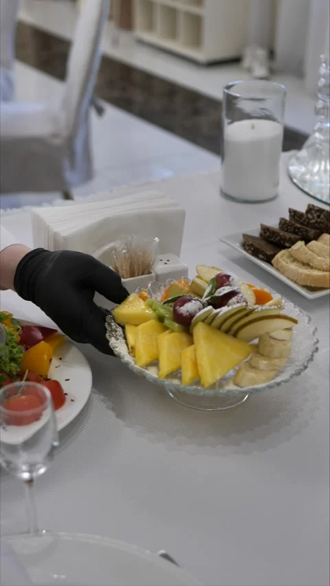 Waiter puts dish on table. festive table setting. luxury event organization Stock Footage 306885163