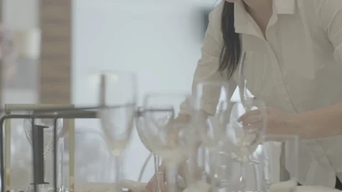 The waiter puts a glass on the table. table setting Stock Footage 110910751