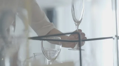The waiter puts a glass on the table. table setting Stock Footage 110910985