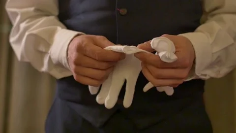 Waiter puts gloves on hands Stock Footage 71430011
