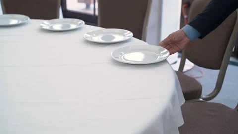 Waiter puts plates on the table for dinner Video stock 186975866