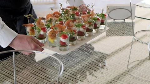 Waiter puts snacks on a tray Stock Footage 136820203