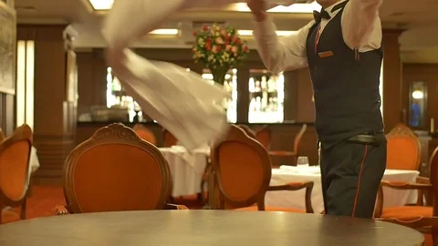 Waiter puts tablecloth with a flourish Stock Footage 71468357