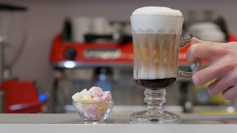 Waiter putting coffee next to the marshmallows on a bar. Video stock 151098950