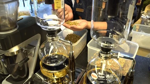 A waiter selecting coffee beans at a coffee bar in Beijing Stock Footage 85665453