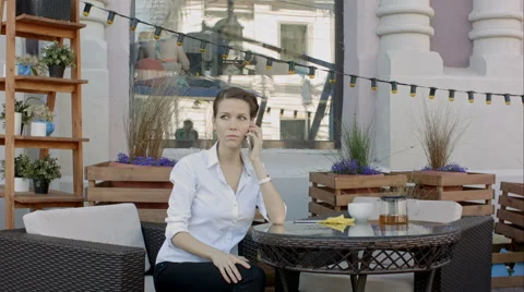Waiter server at table working, while woman talking cell phone Vídeos de archivo 65249668