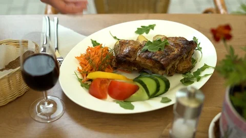 The waiter serves to customer a meat dish from the chef in a summer restaurant. Stock Footage 101245673