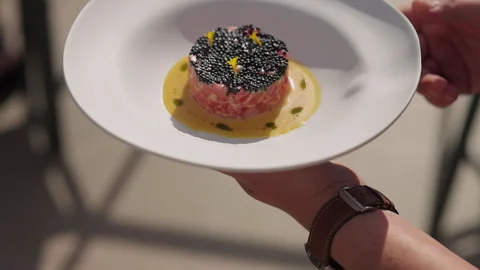 Waiter Serves Dish Of Red Fish And Black Caviar To Customer. Video stock 275571720