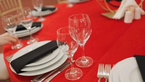 The waiter serves a festive round table with cutlery and crockery Stock Footage 122037307