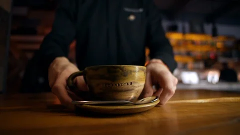 The waiter serves a mug of coffee Stock Footage 129173005