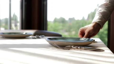 Waiter serves a table in an elite restaurant close-up. Men's hands arrange Stock Footage 156429372