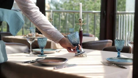 Waiter serves a table in an elite restaurant close-up. Men's hands arrange Video stock 156429786