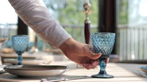 Waiter serves a table in an elite restaurant close-up. Men's hands arrange Video stock 156429956