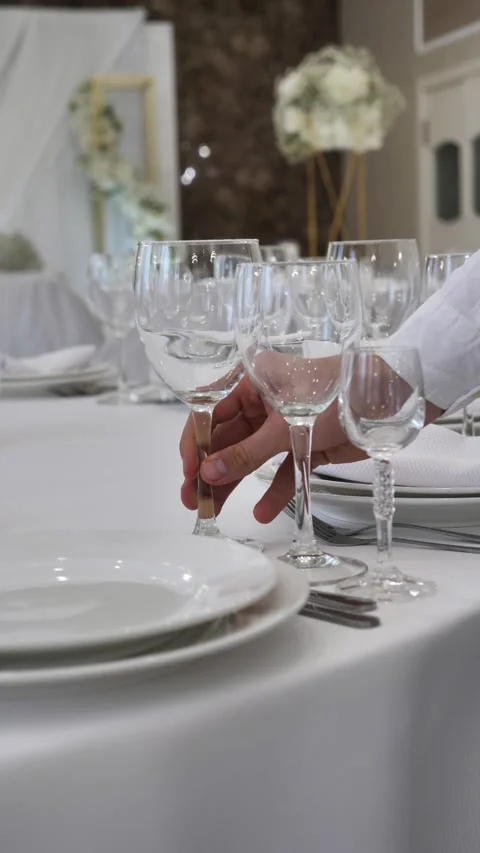 A waiter serves a table in a restaurant. sets a table in a restaurant. Stock Footage 313963142