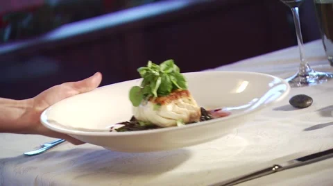Waiter serving appetizer on table in restaurant Stock Footage 54592265