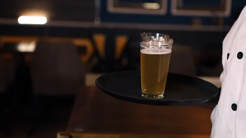 Waiter is serving beer for customers in the pub Stock Footage 119114476
